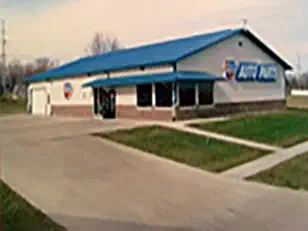 Auto parts store in a steel building with a blue roof