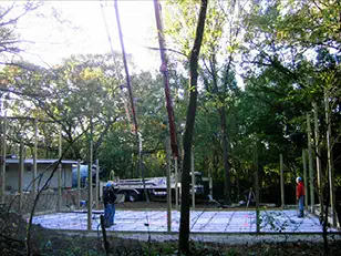 Crew setting forms for a slab among the trees