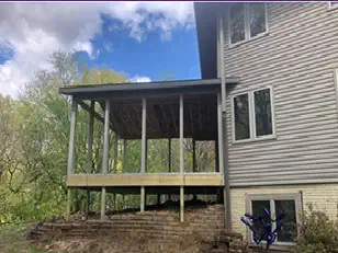 Covered porch framed off a two-story house