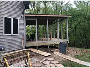 Screened porch with a stone path in front