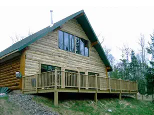 Log-sided cabin with a wraparound deck