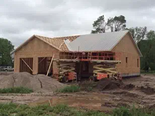 Framed house with a metal roof going on