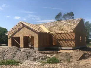 House sheathed and roofed during framing