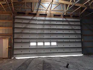 Large insulated overhead door inside a machine shed