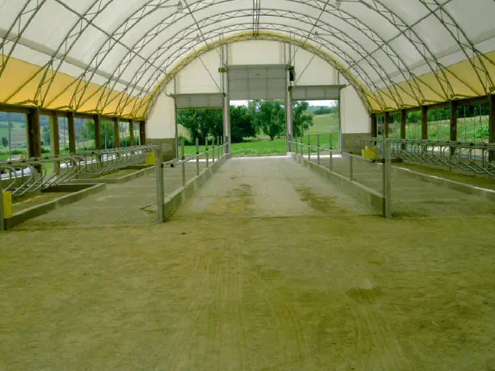 Finished concrete floor running the length of a long barn aisle