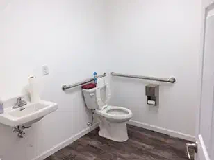 Finished accessible restroom with grab bars