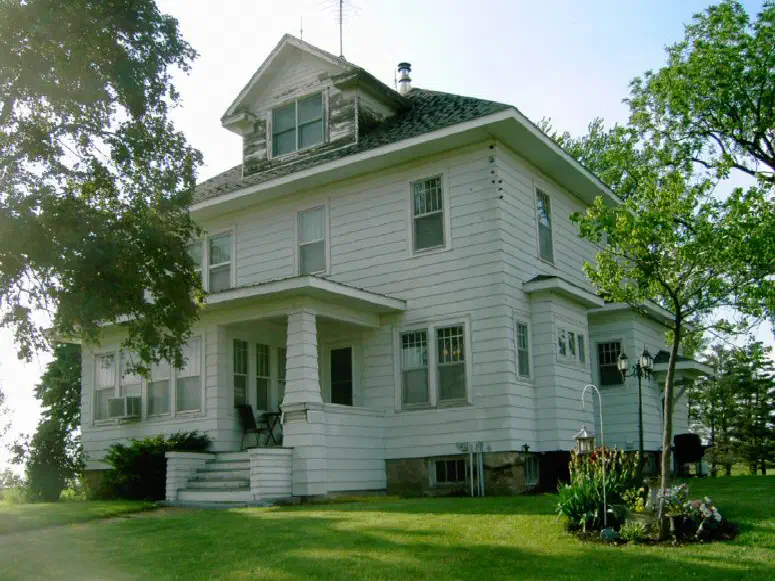 The farmhouse with its old shingle roof