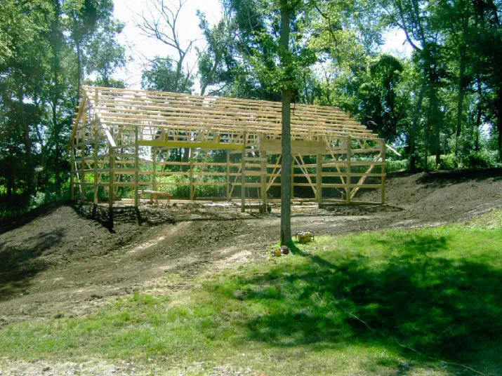 Wood frame building standing on a finished pad among the trees