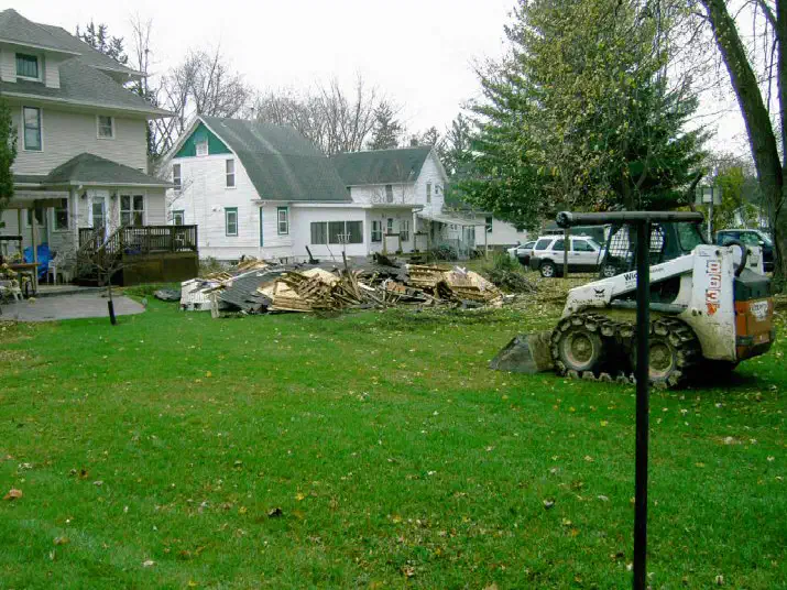 Skid loader clearing the old garage site